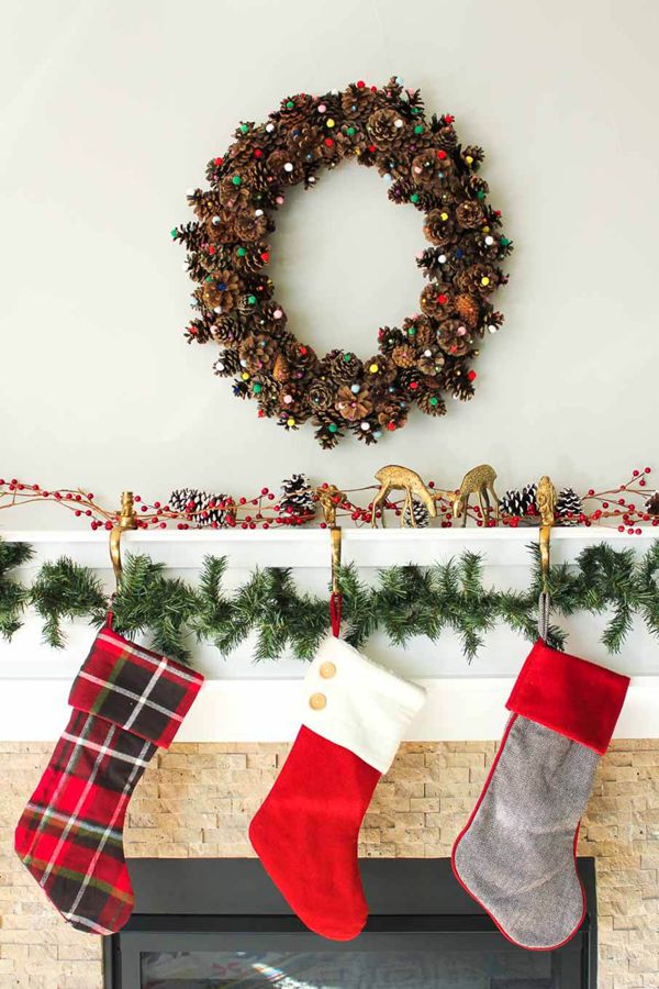 DIY pinecone wreath decorated with colorful pom-poms